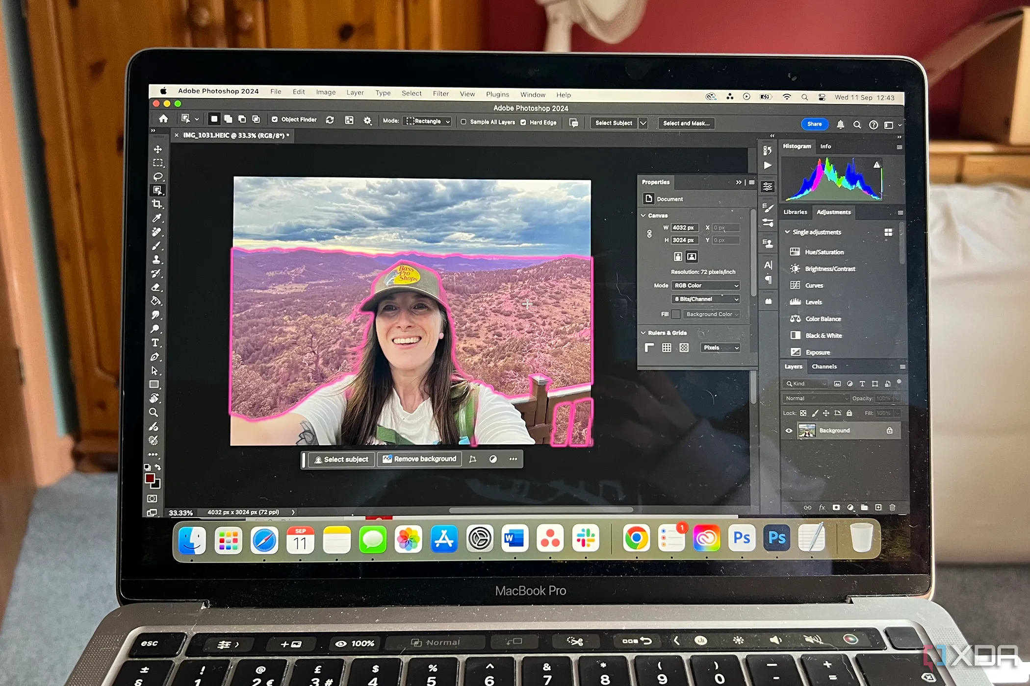 A MacBook with Adobe Photoshop showing the Object Selection tool on a photo of a woman