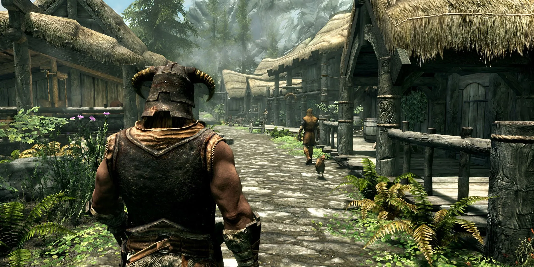 Dragonborn đi bộ qua một ngôi làng trong The Elder Scrolls V: Skyrim