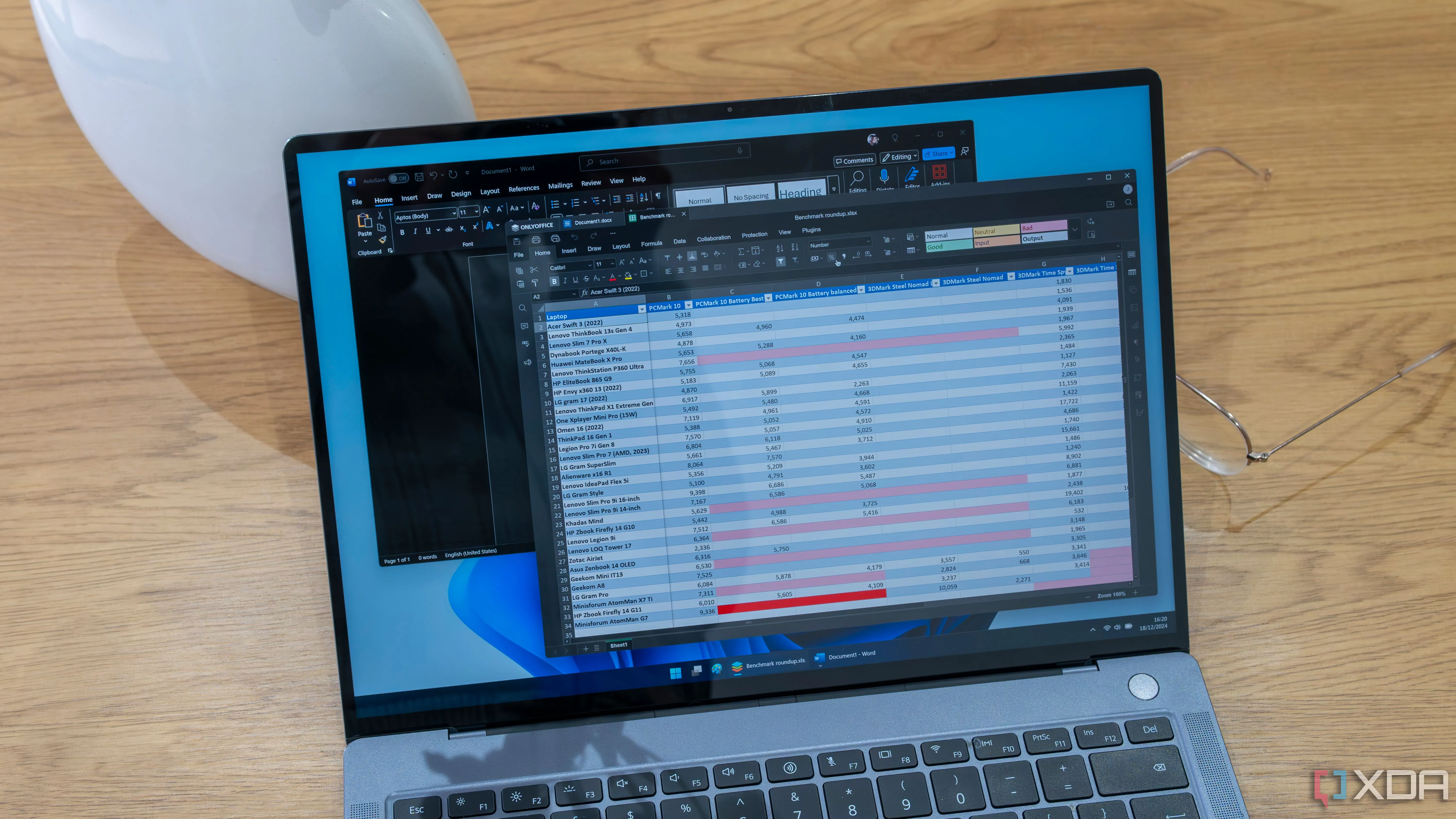 Laptop chạy OnlyOffice trên nền cửa sổ Microsoft Word trên Windows 11