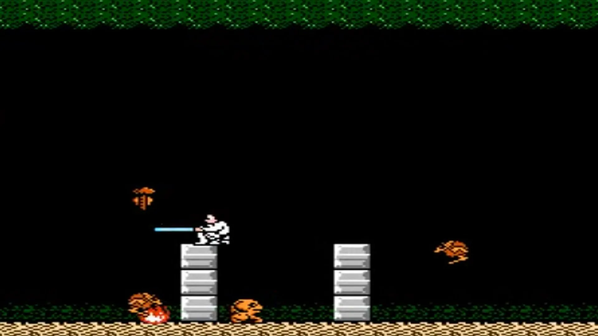 Lối chơi game Star Wars trên NES với Luke Skywalker bắn tia năng lượng vào kẻ thù trong một hang động