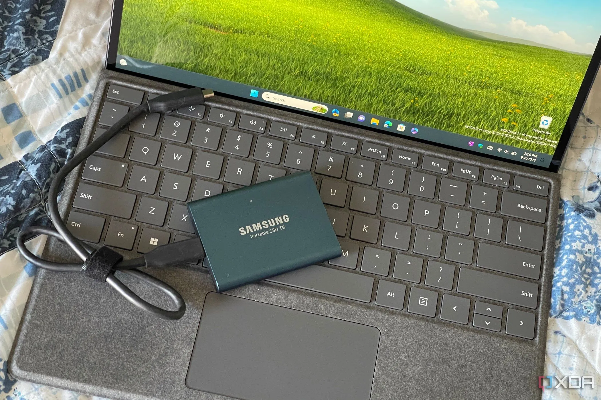 Một chiếc Surface Pro 8 với SSD ngoài, tượng trưng cho việc sao lưu dữ liệu trên Windows 11