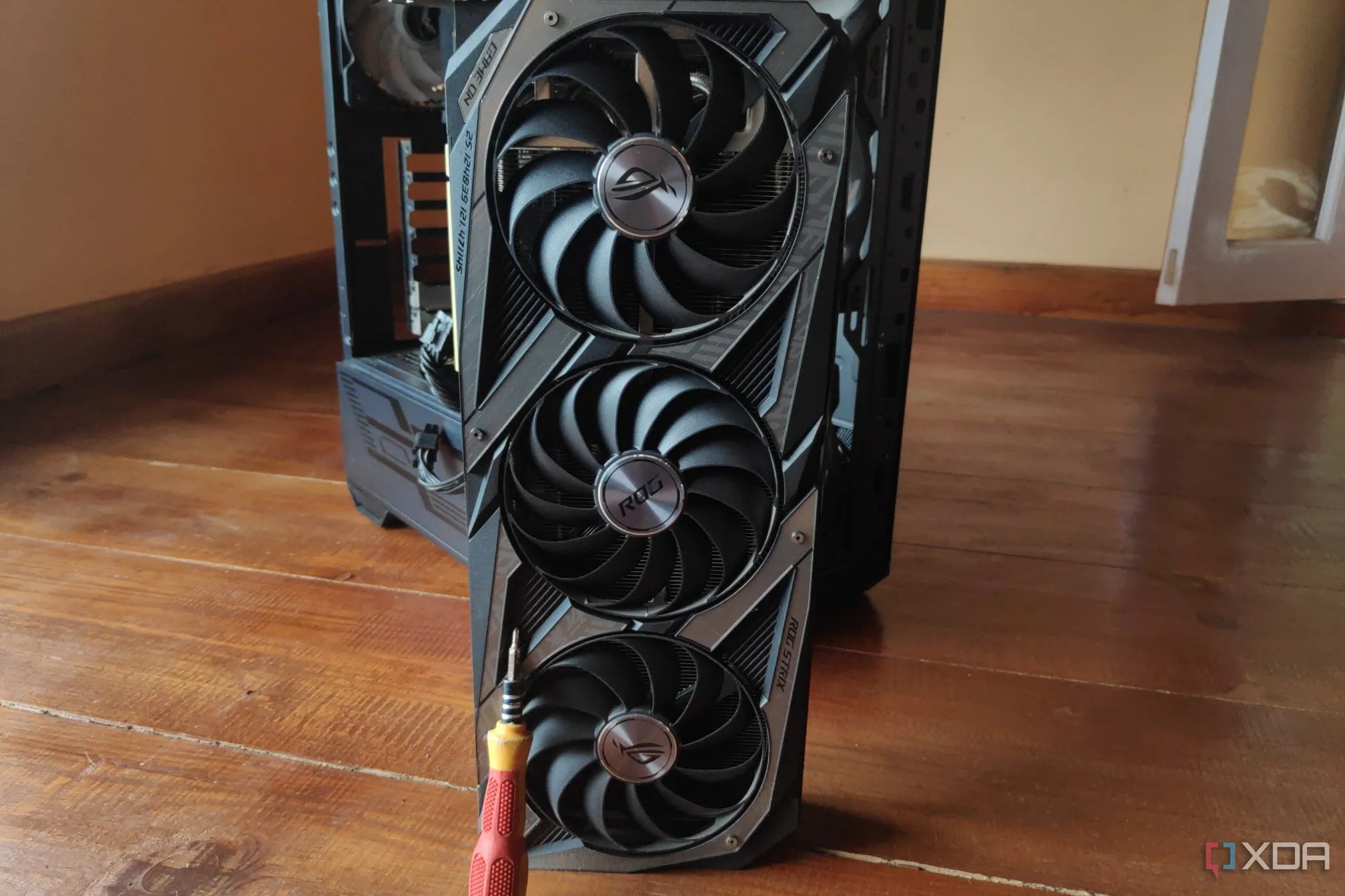 Một chiếc tua vít đặt trên card đồ họa NVIDIA GeForce RTX 3080 Ti, tượng trưng cho quá trình vệ sinh hoặc tháo lắp GPU để làm mát.