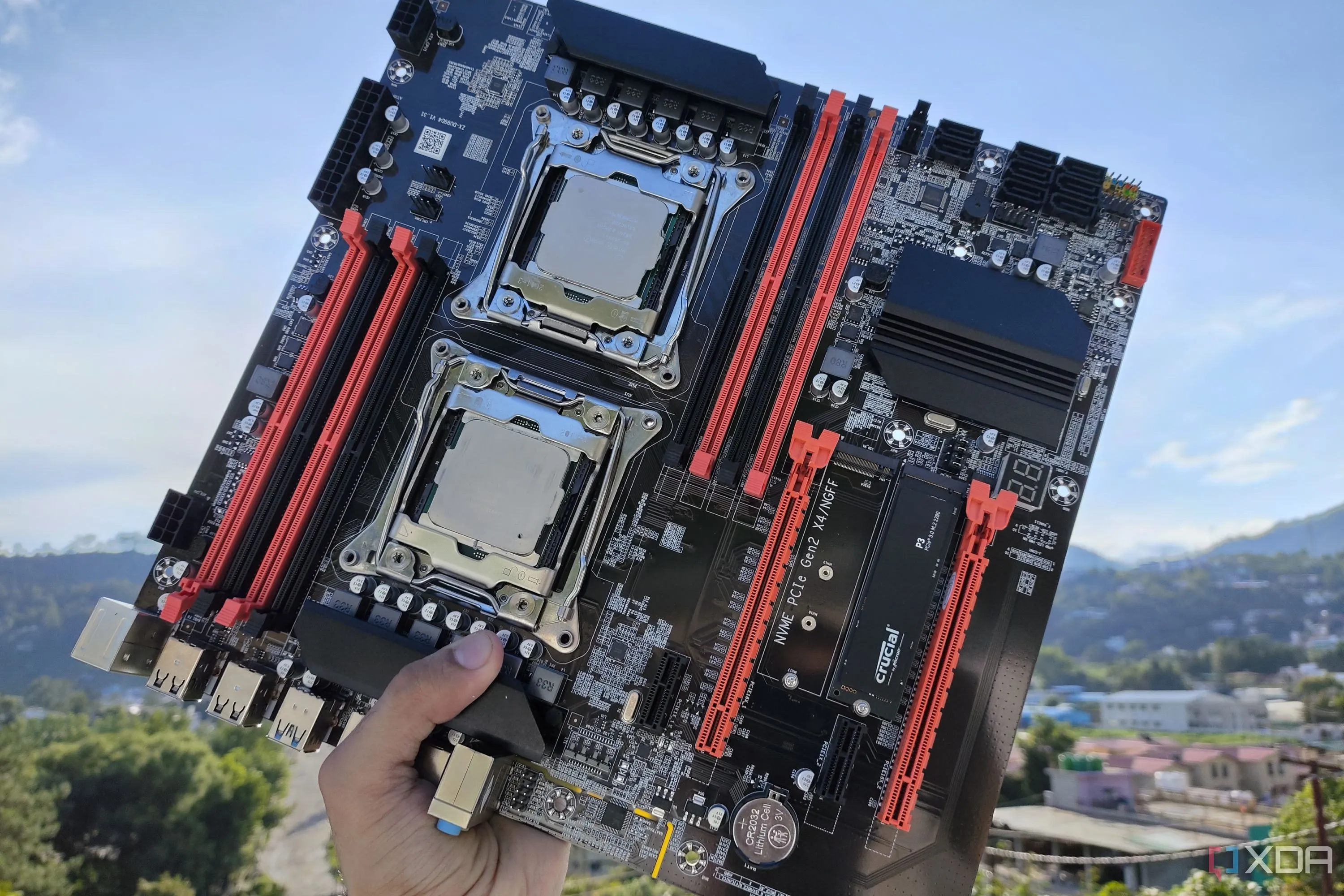 Một người đang cầm bo mạch chủ server X99 với hai CPU Intel Xeon được lắp đặt, thể hiện sự nâng cấp lên phần cứng máy chủ.