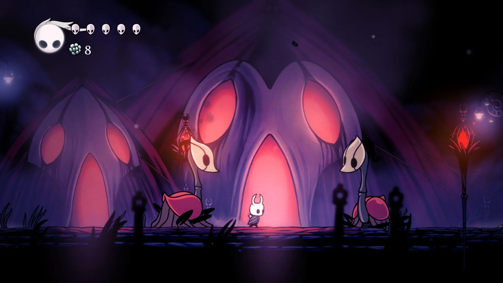 Nhân vật chính của game Hollow Knight đứng giữa hai sinh vật, minh họa cho một trong những tựa game có tầm ảnh hưởng văn hóa đang giảm giá trên Steam.