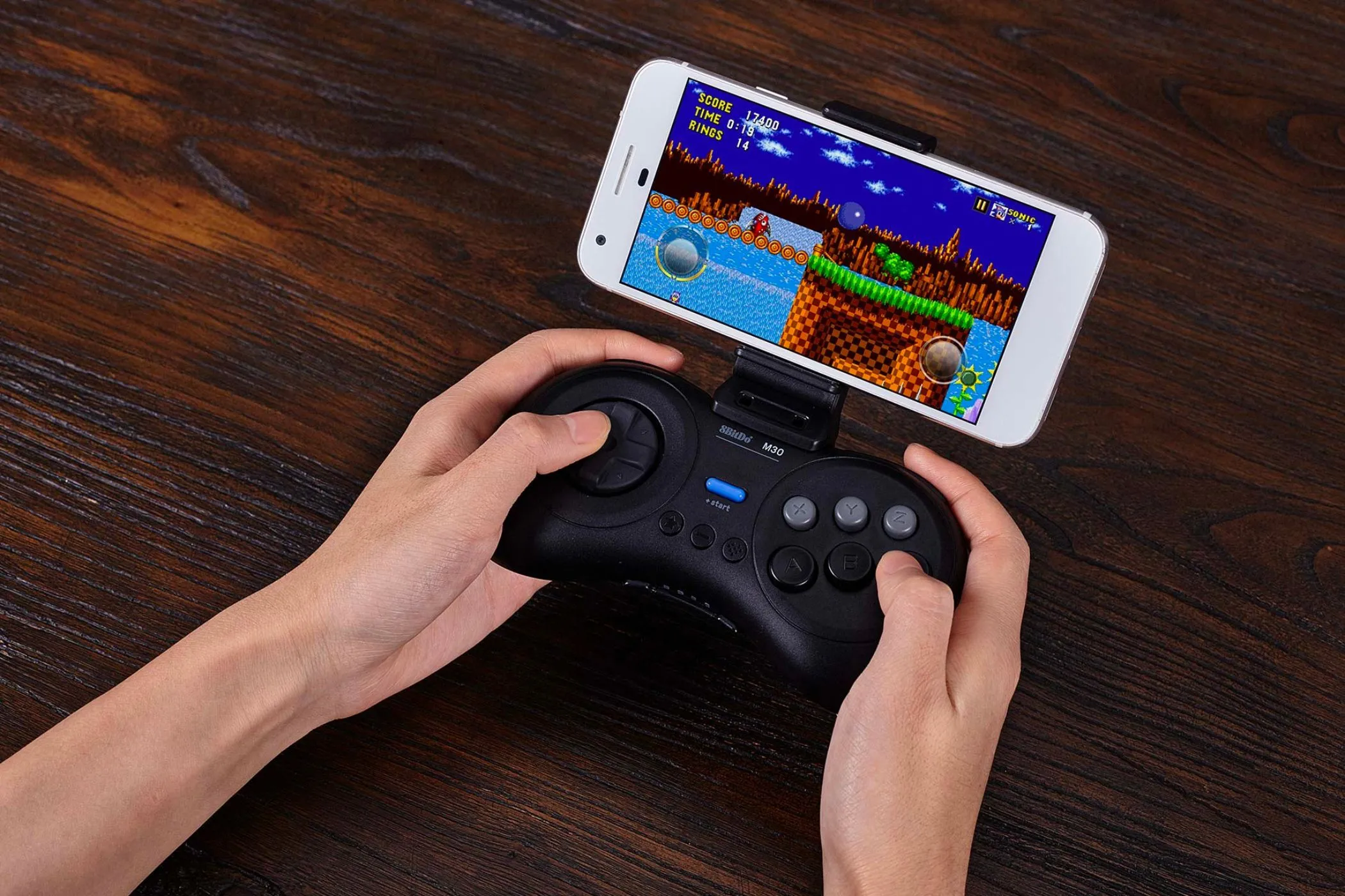 Tay cầm chơi game retro 8Bitdo M30 được sử dụng để chơi game trên điện thoại thông minh, thể hiện sự hoài cổ trong game.